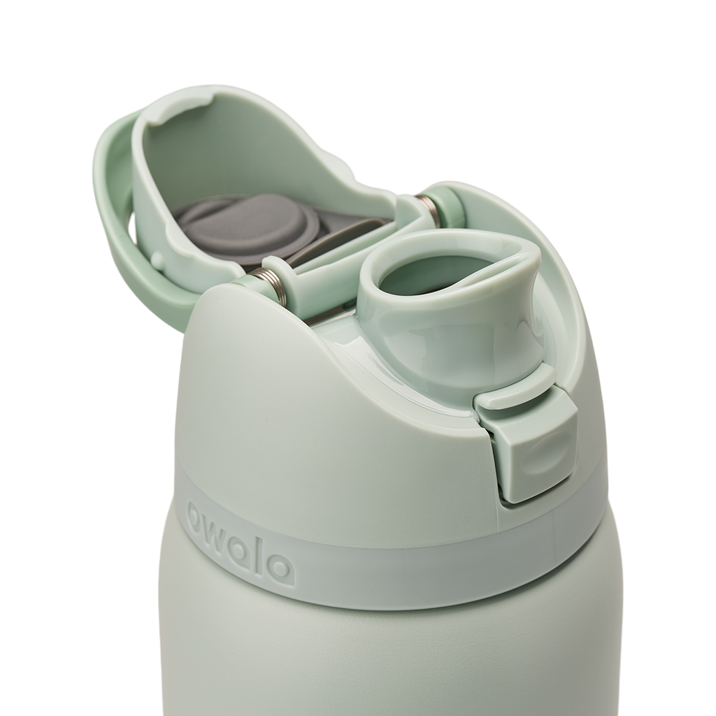 Owala FreeSip 32oz in Summer Paradise, lid detail with flip cap open exposing the FreeSip spout, mint green lid and flip cap with gray stainless steel spout interior visible