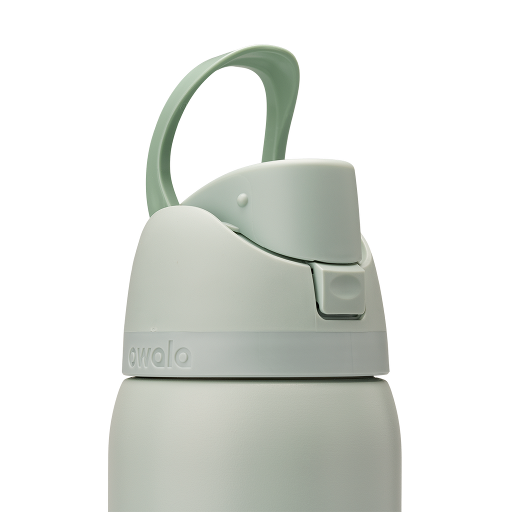 Owala FreeSip 32oz in Summer Paradise, lid detail showing closed flip cap with mint green carry loop arched over the top, sage body with embossed Owala logo and accent band at lid base
